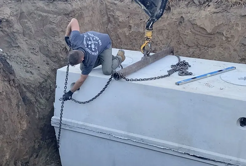 Tank Installation, Lowering Tank into Hole via Crane